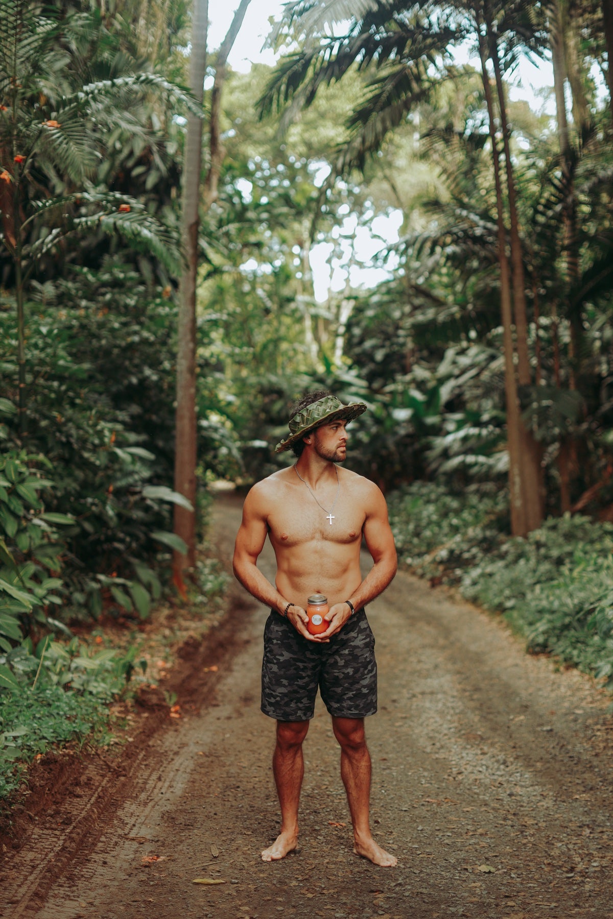 Breland holding a fresh smoothie among tropical trees