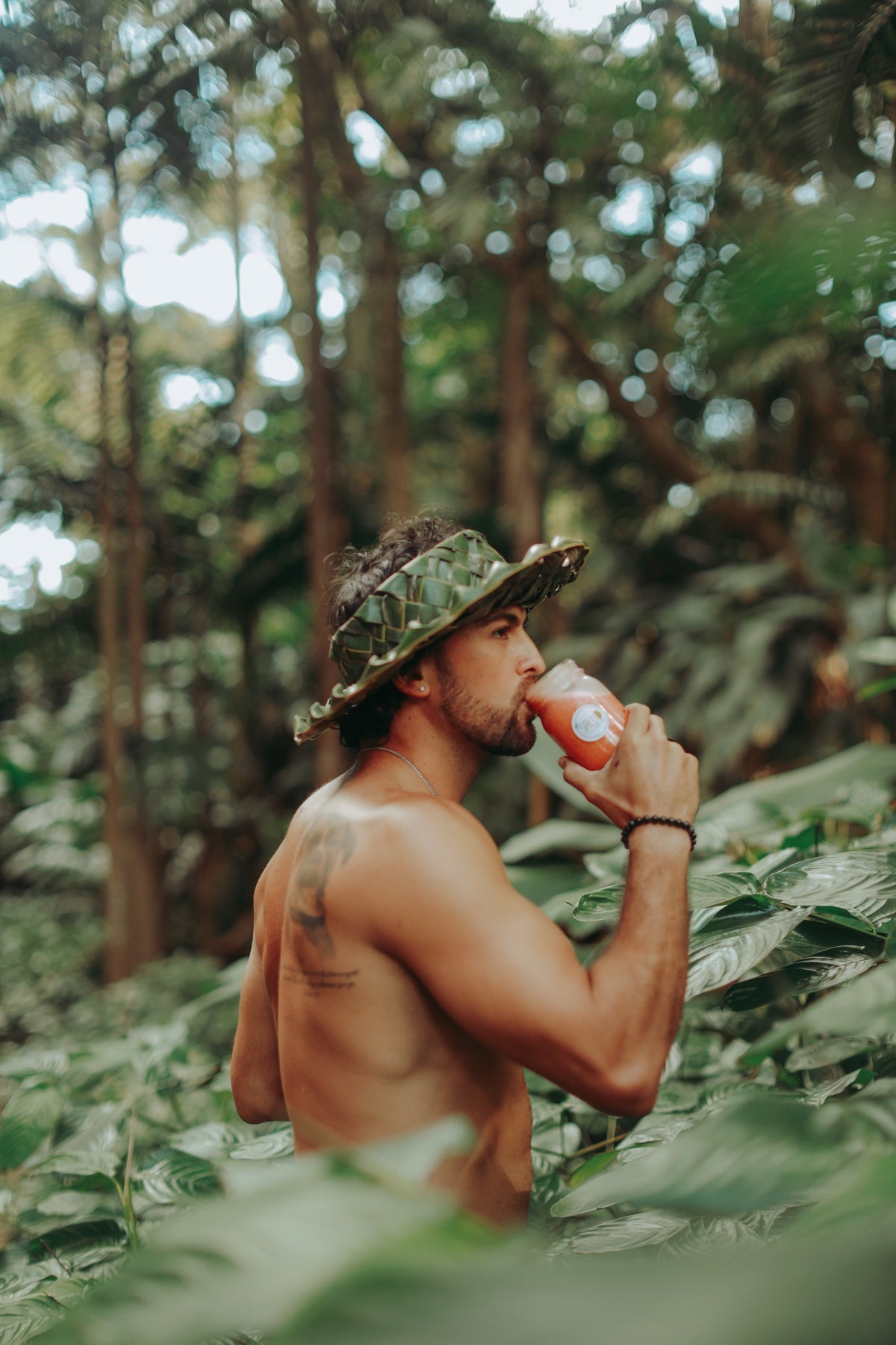 Breland enjoying a fresh Mana Living smoothie outdoors in Hawaiʻi